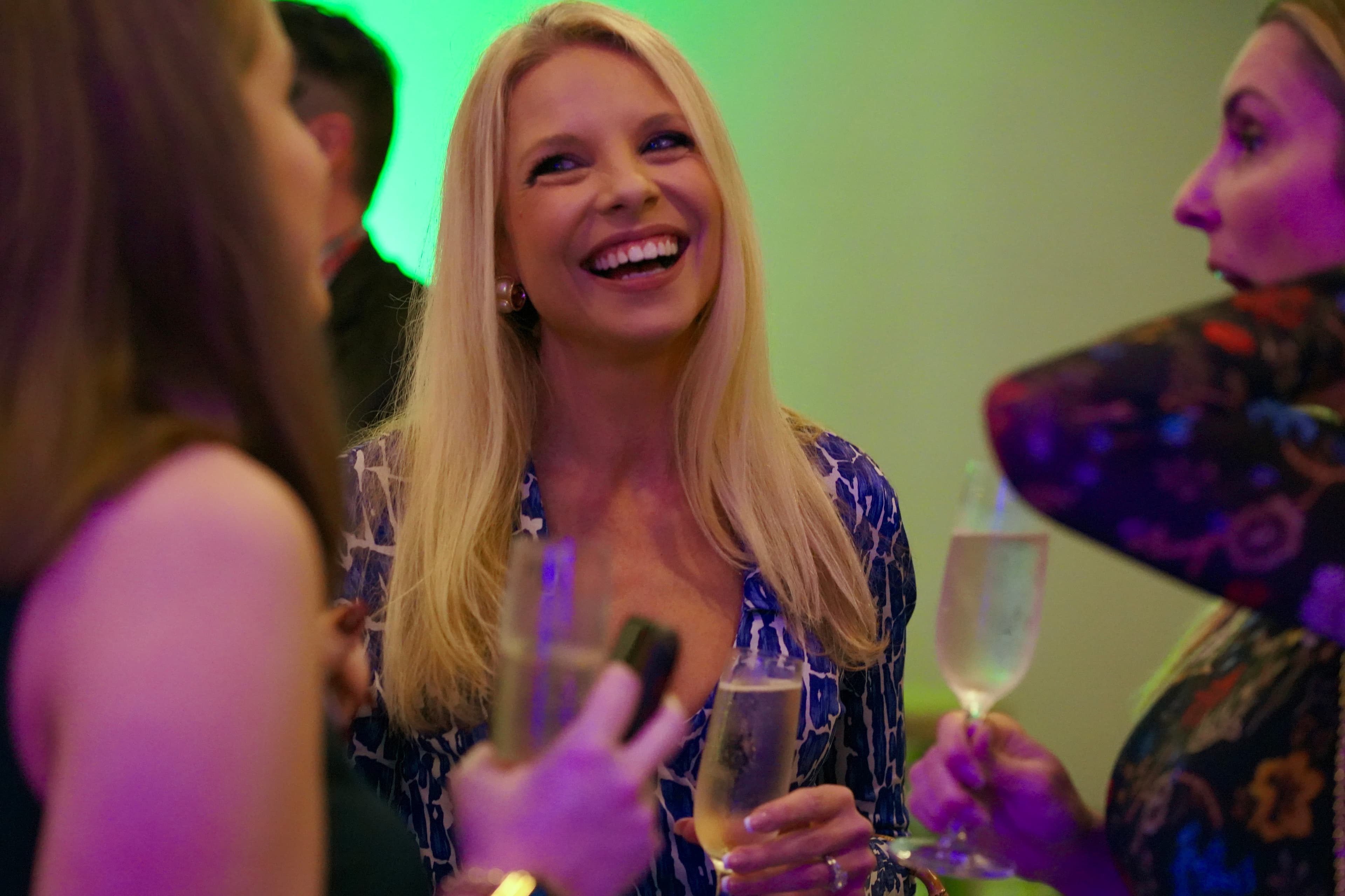 Attendees laughing together at the reception